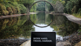 Developer testimonial on how to relax with nature while working remotely. Laptop screen spells Work hard. Travel harder.